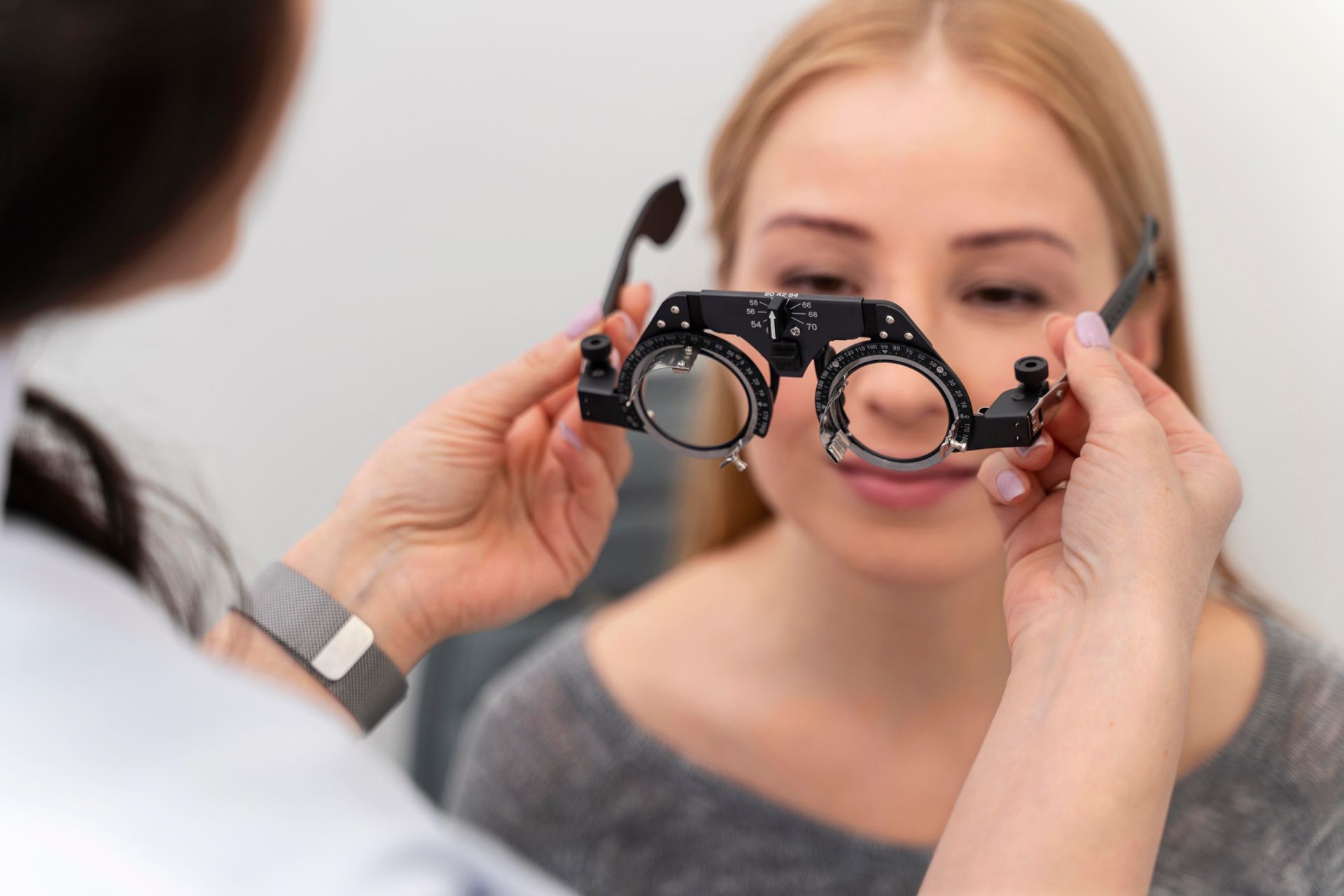 Person placing a contact lens on their brown eye.