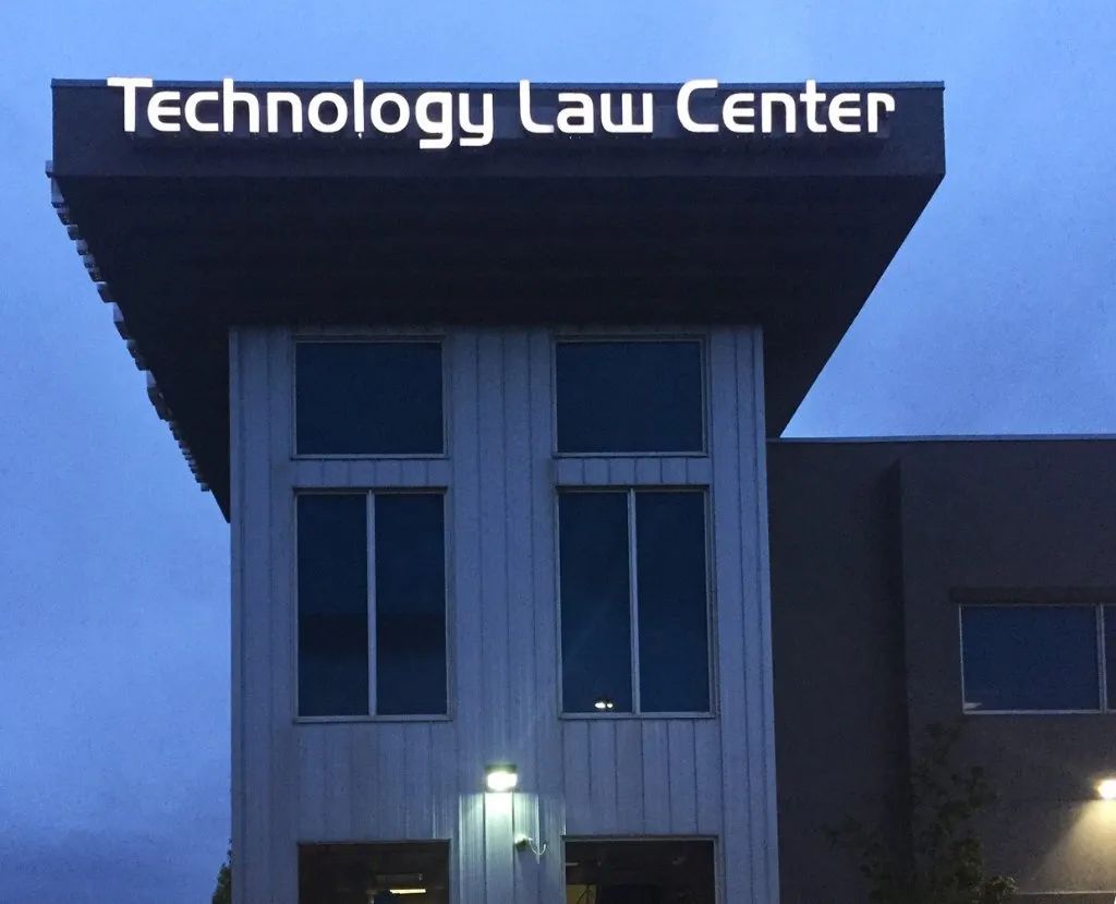 Technology Law Center building at dusk with illuminated sign and lit entrance