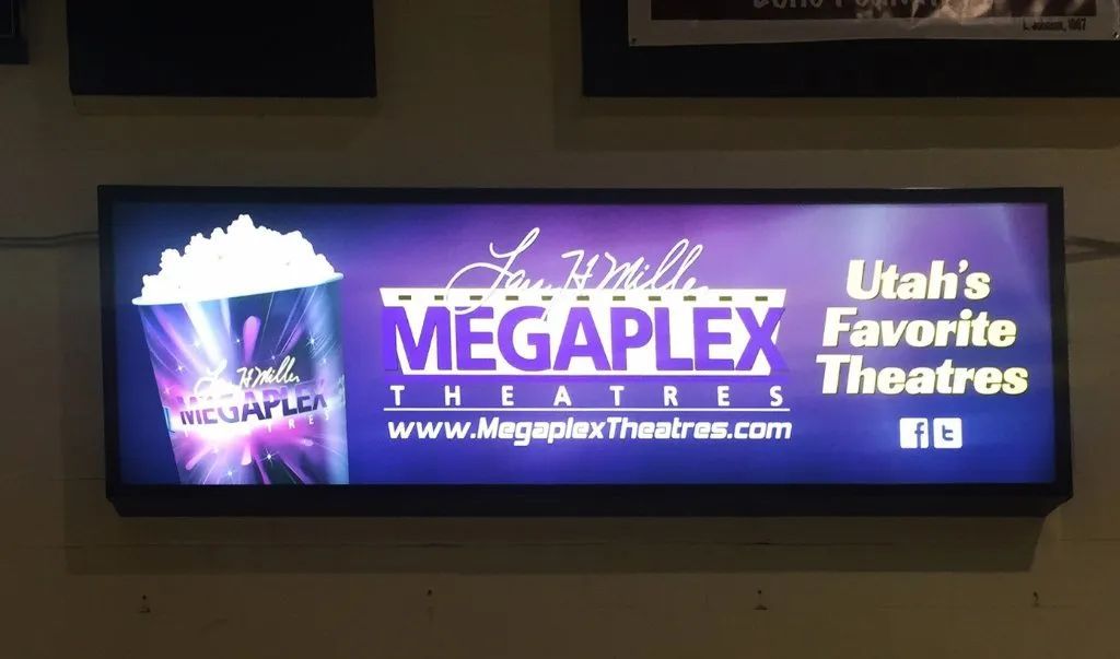 Megaplex Theatres sign in purple and white advertising Utah’s favorite theaters.