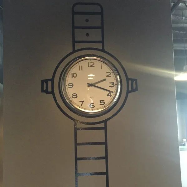 Analog wristwatch illustration with a round white dial and blue striped band on a beige background