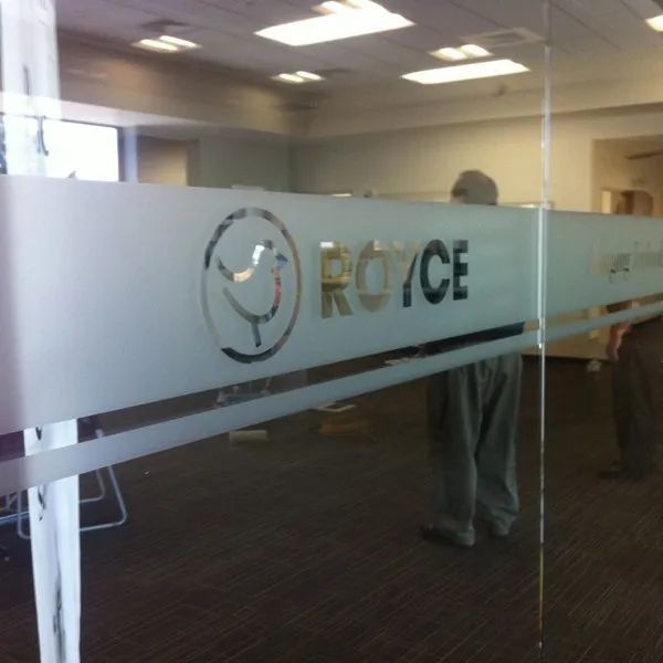 Office lobby with frosted glass wall logo and the word “ROICE” on the partition