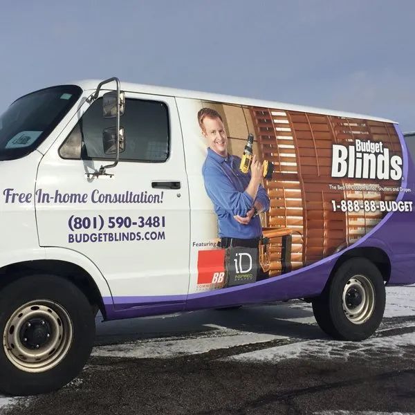 Budget Blinds service van with company branding and free in-home consultation text.