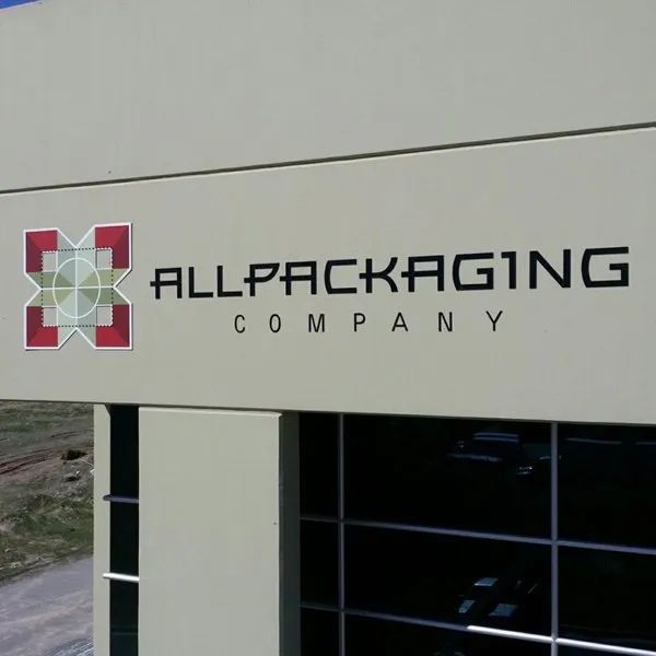 Allpackaging Company sign with red logo on a building facade