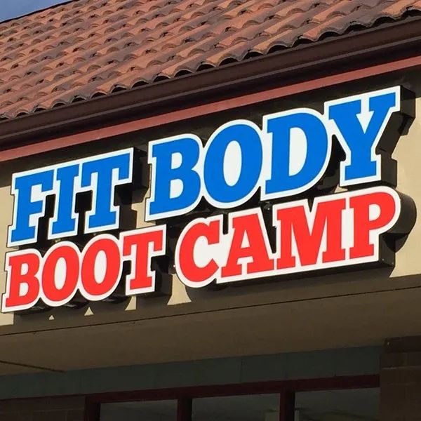 Blue and red FIT BODY BOOT CAMP sign on a storefront