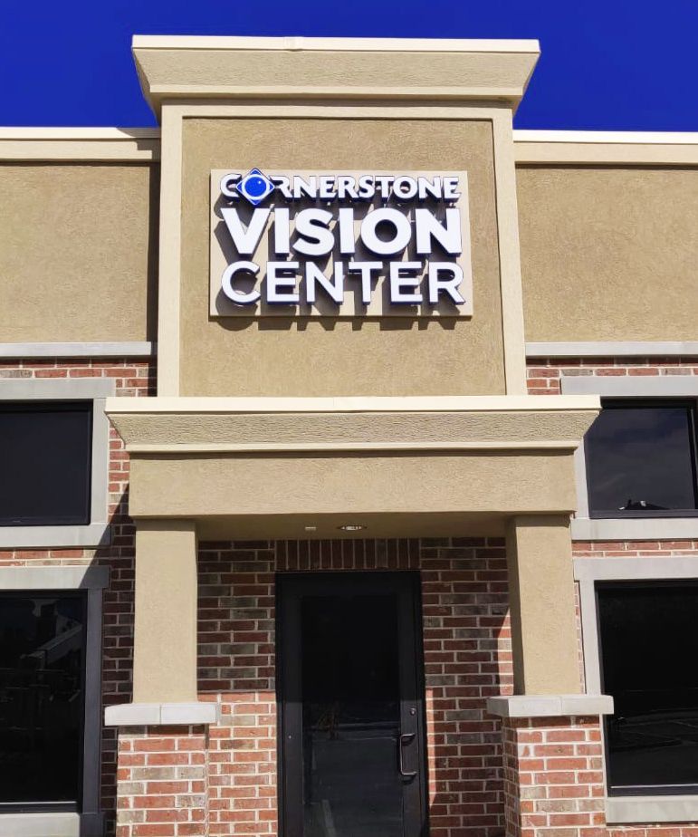 Cornerstone Vision Center storefront with tan stucco facade and brick entrance