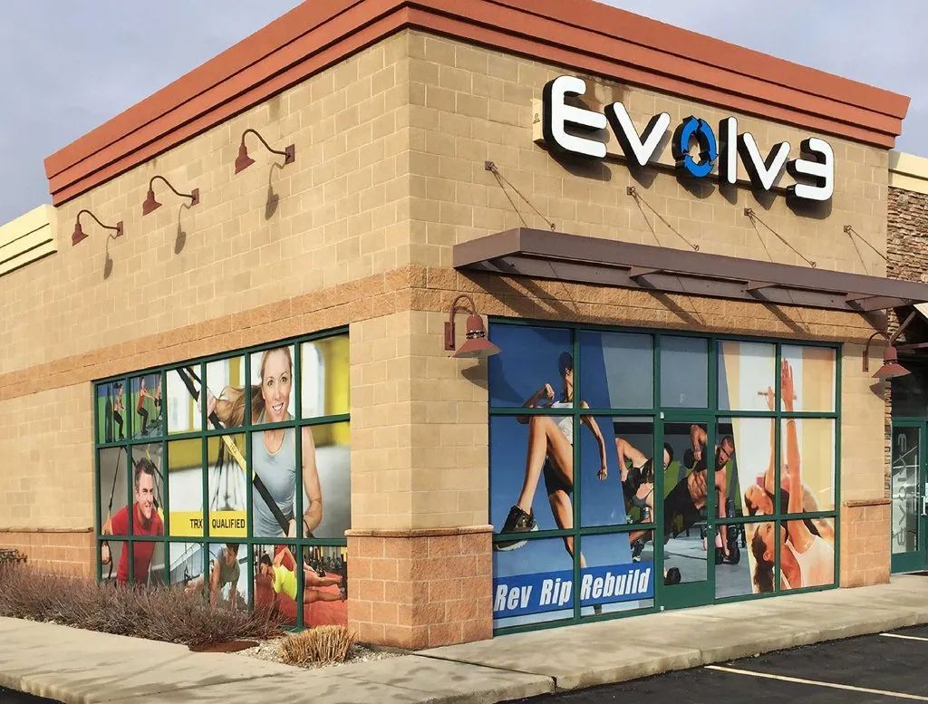 Evolve fitness studio storefront with large wall graphics and glass windows