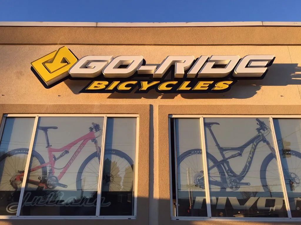 Go-N-RO Bicycles storefront sign above windows displaying bicycles