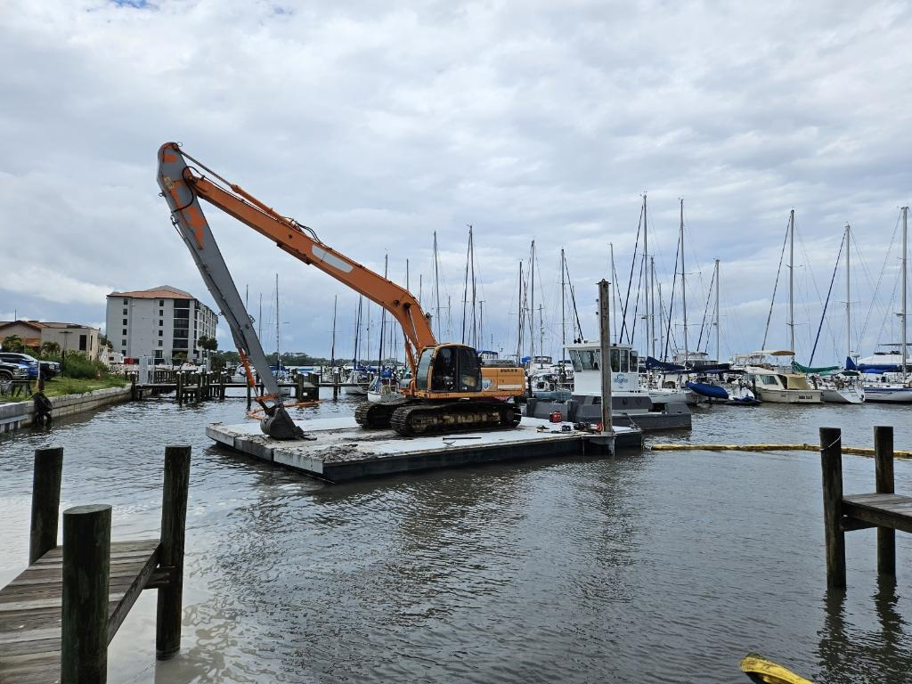 Hydraulic Excavator Digging Up The Sand In The River — Rockledge, FL — Central Sand Inc.
