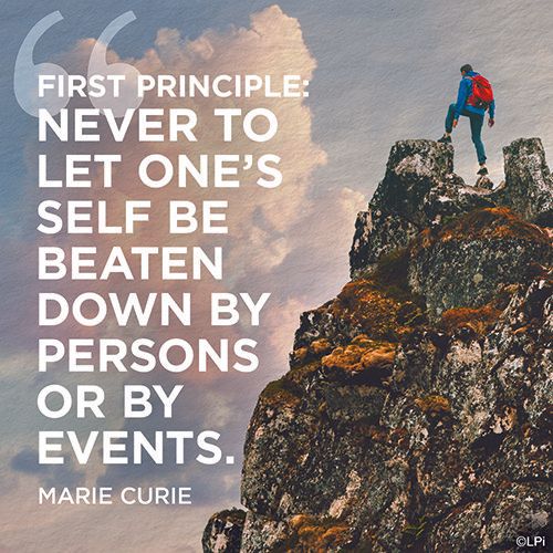 A person standing on top of a mountain with a quote from Marie Curie.