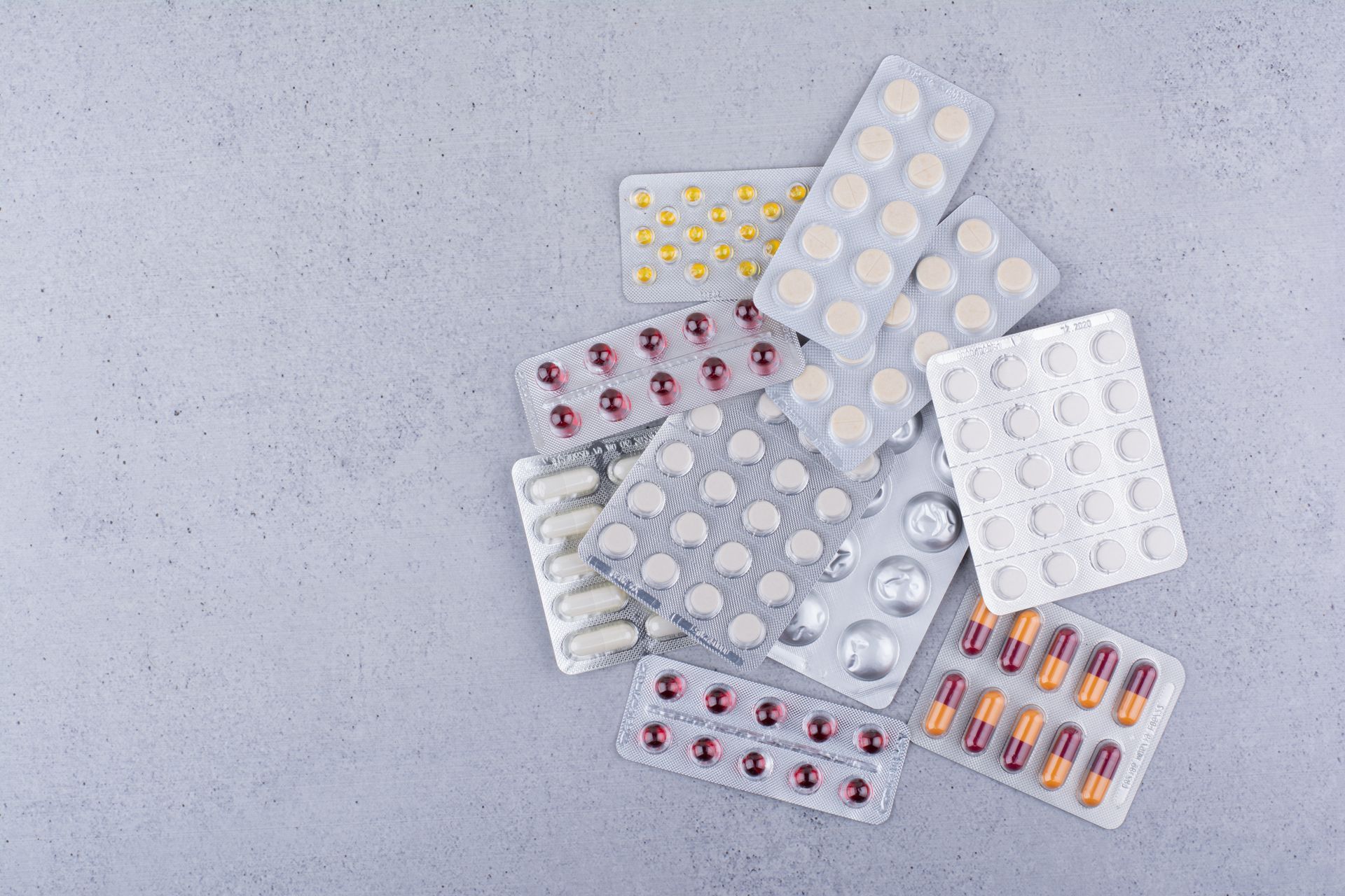 a pile of pills in blister packs on a table .