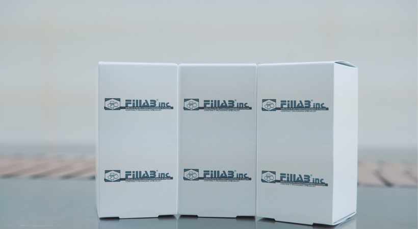 three white boxes with arabic writing on them are sitting on a table .