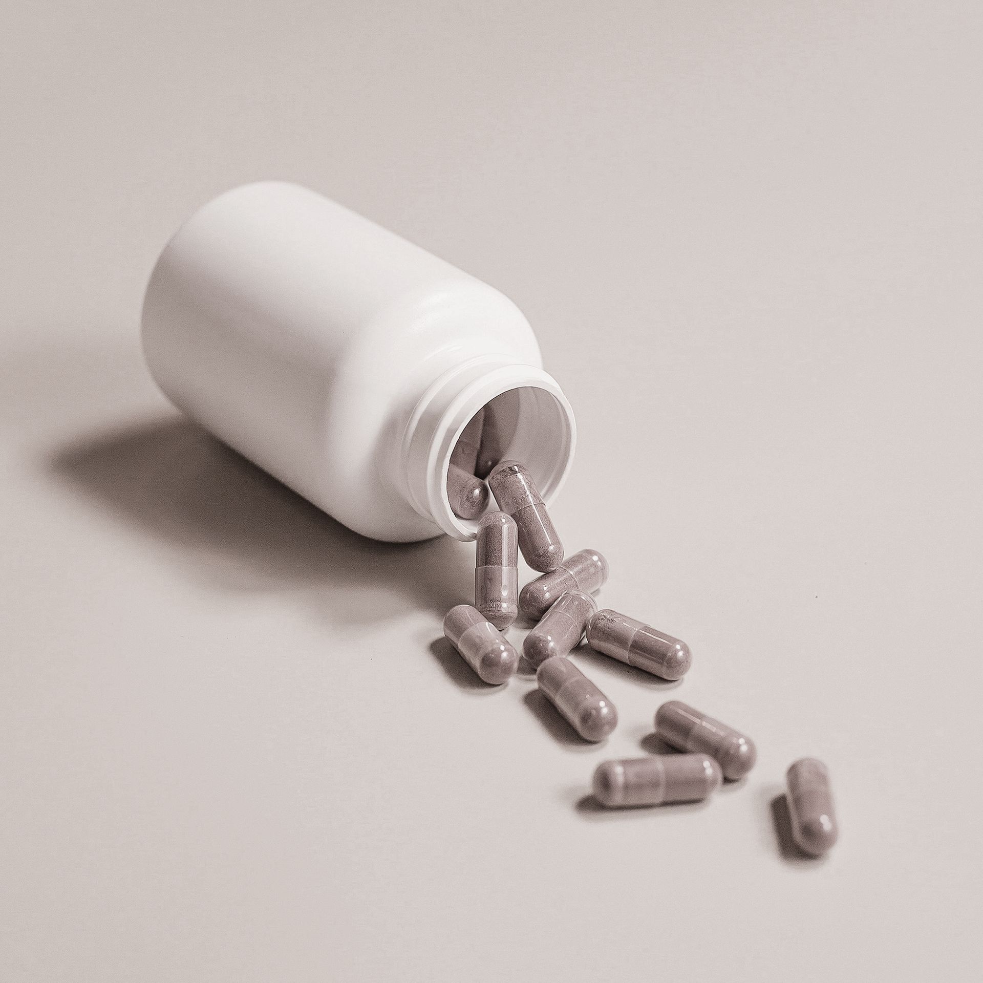 a bottle of pills is pouring out of it on a table .