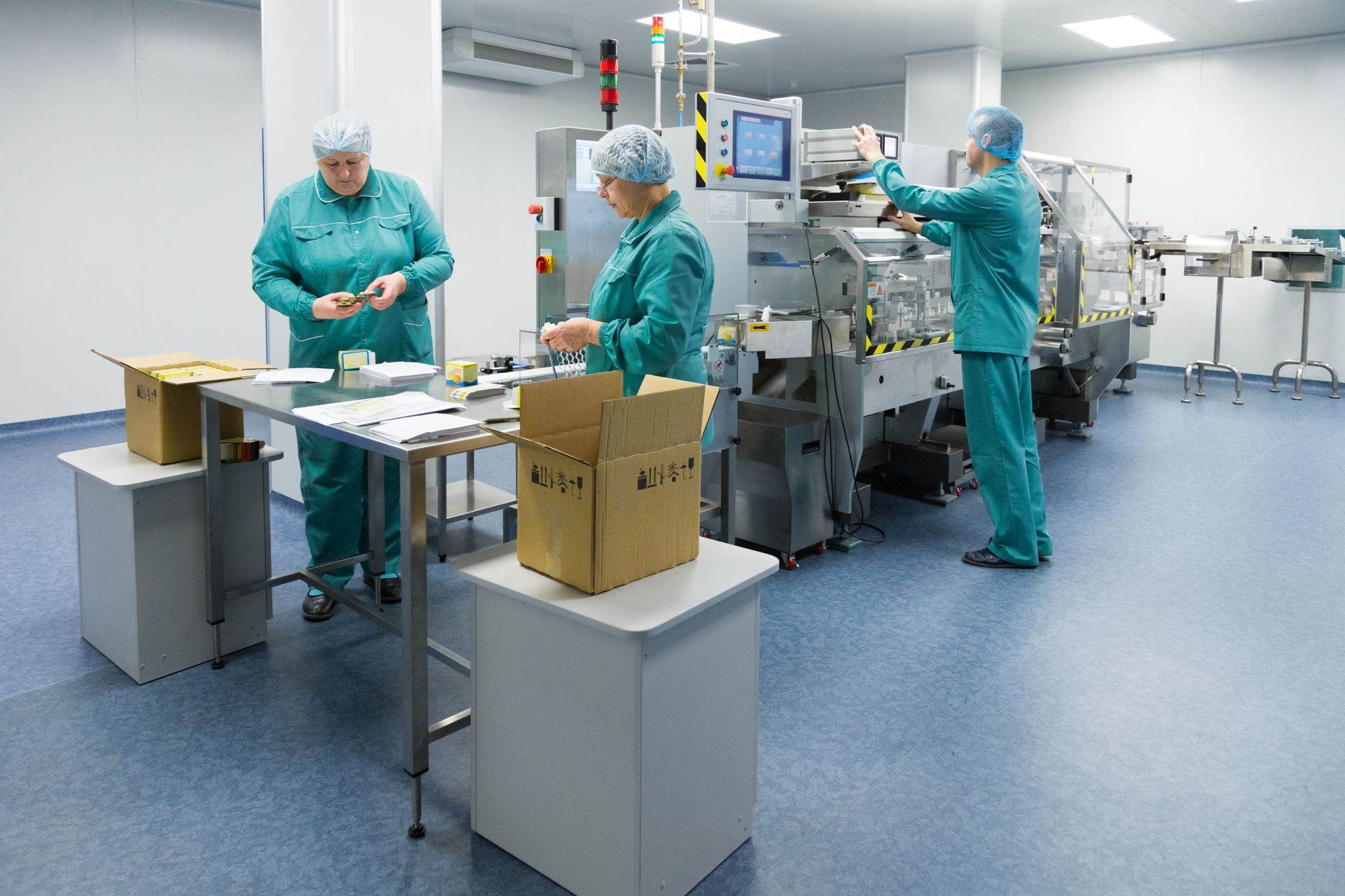 a group of people are working in a clean room .