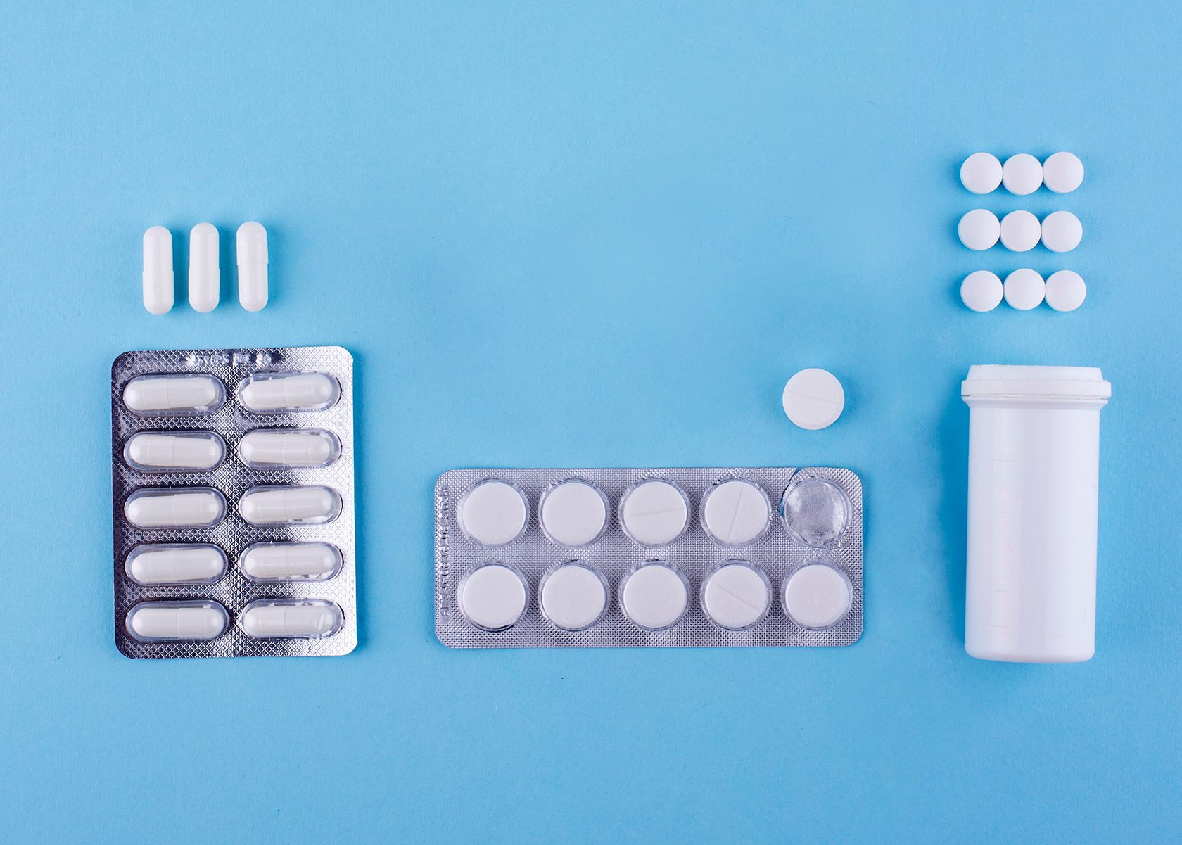 there are many different types of pills on a blue background .