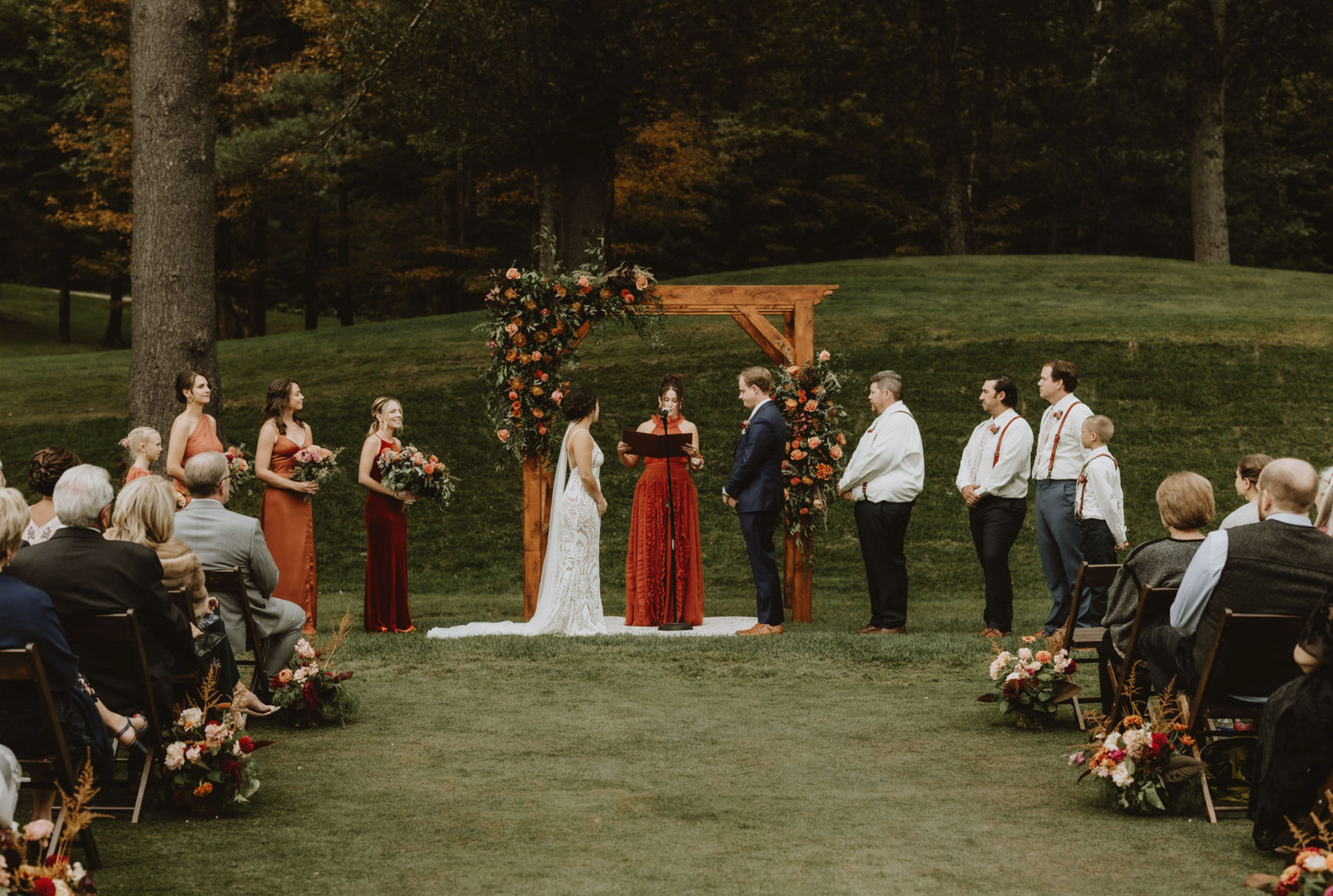 A bride and groom are getting married in front of a crowd of people.