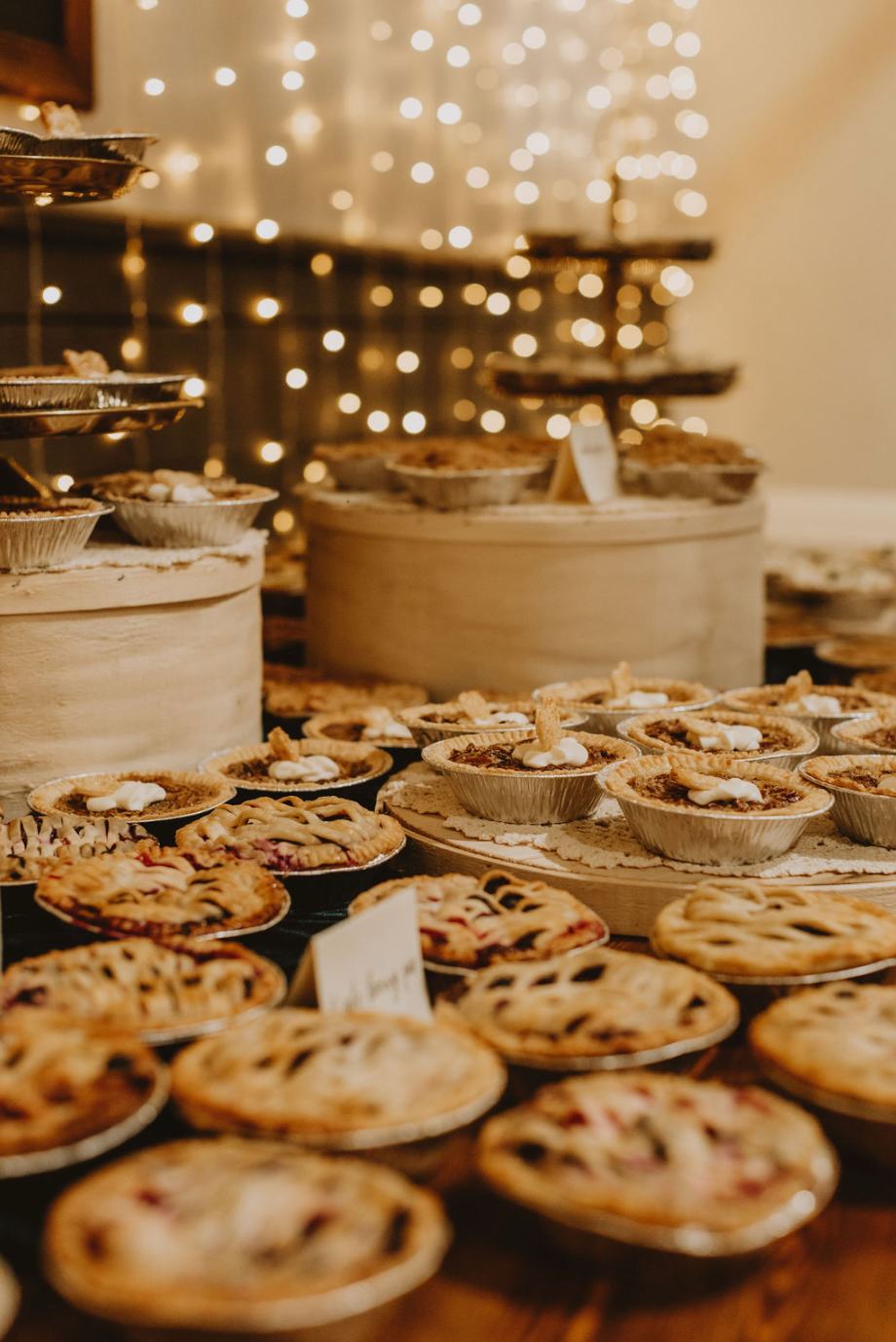 There are many different types of pies on the table.