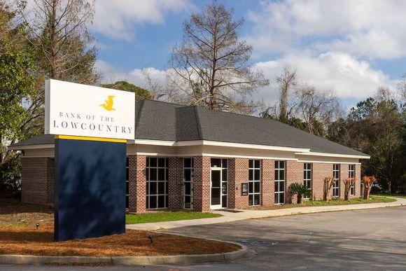 bank of the lowcountry's mt. pleasant red brick building with a sign in front of it with the bank's name and logo