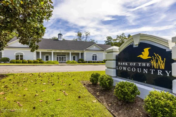 picture of the front of the bank of the lowcountry main branch in walterboro with their sign out front