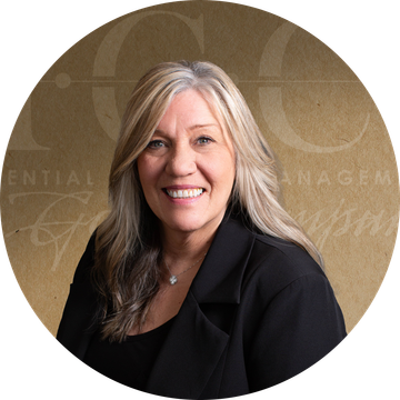 Woman with long blonde hair, smiling, wearing a black blazer. Background has text.
