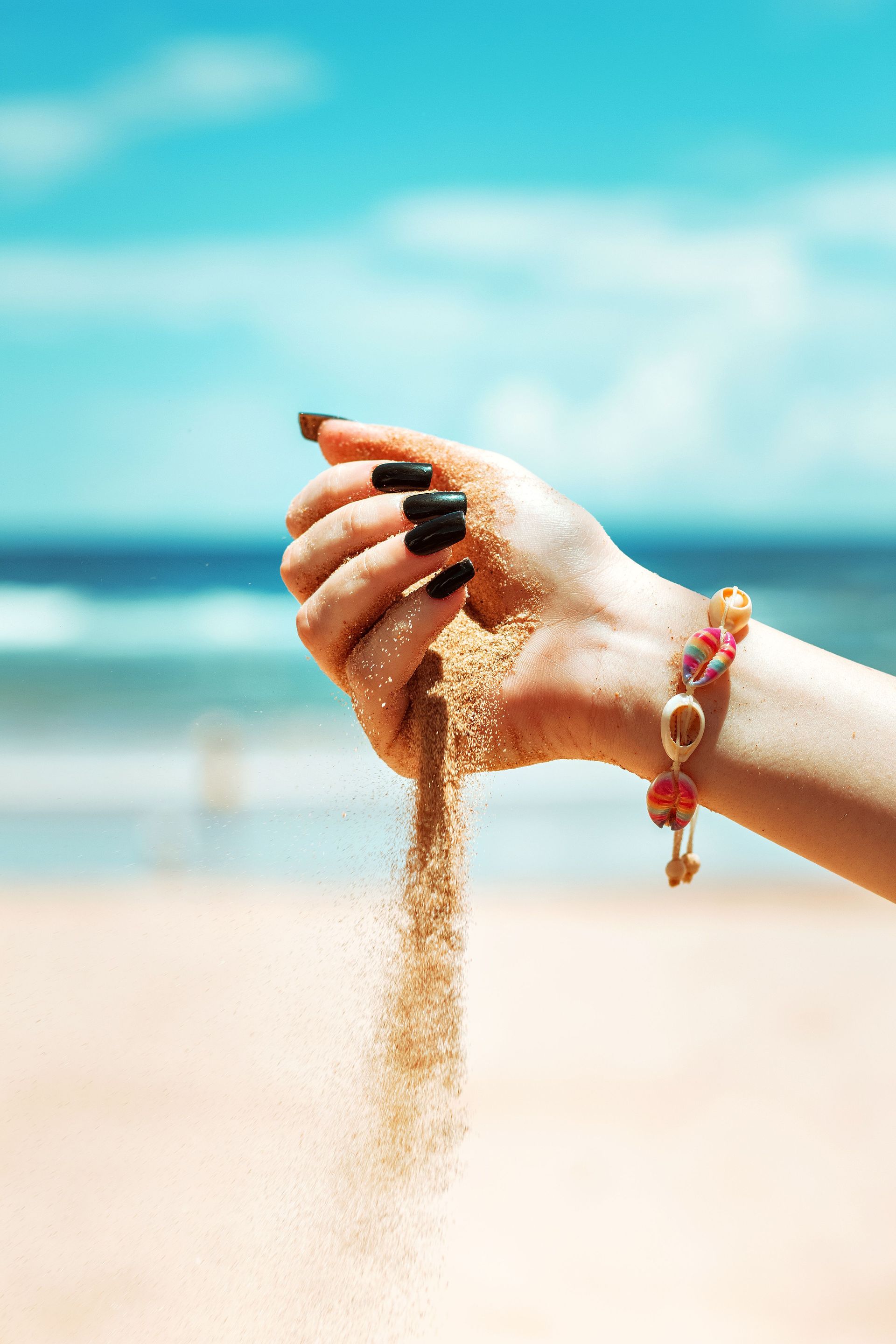 hand holding sand with sky background