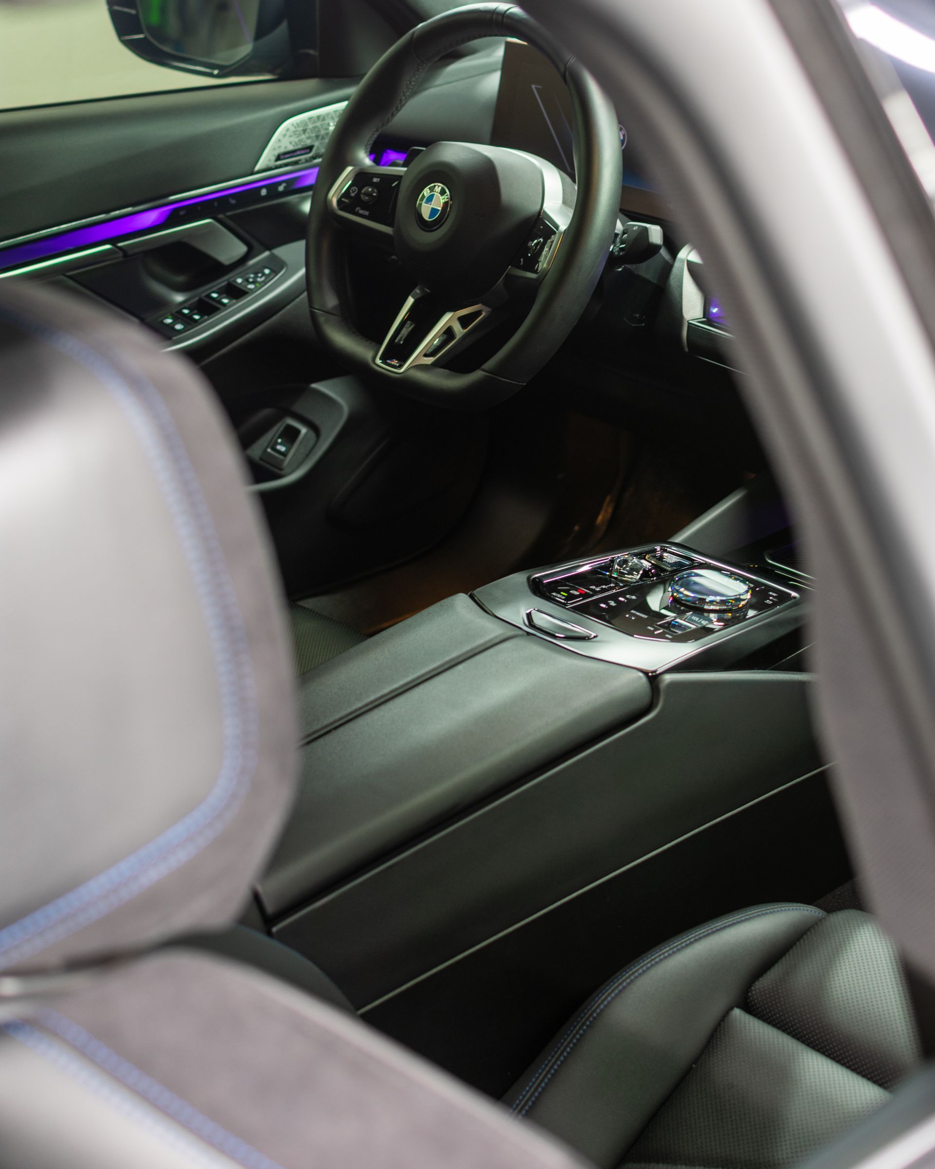 Car interior with smoke and a person using a heat gun on the dashboard console