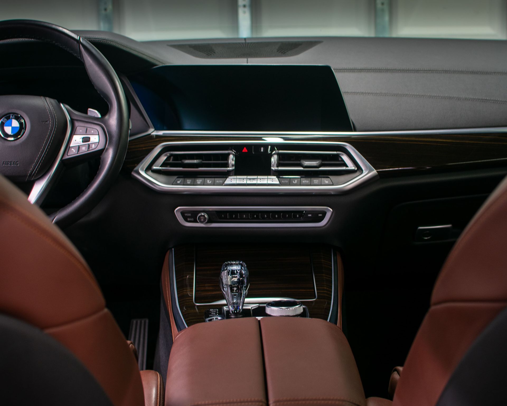 BMW car interior with red leather seats, dashboard display, and center console