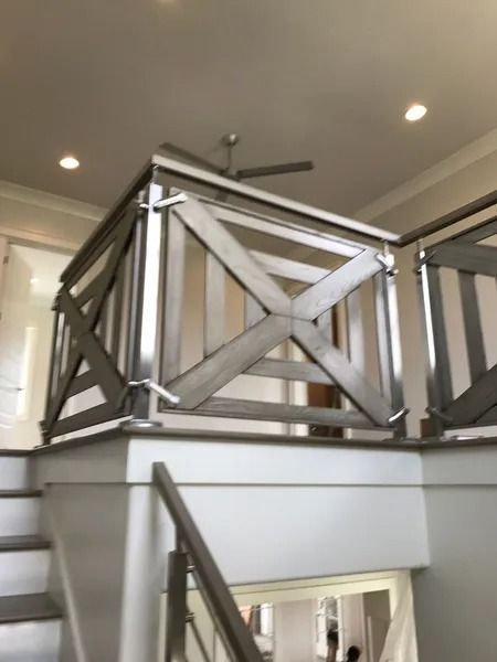 Modern staircase with metal railing in a bright indoor hallway
