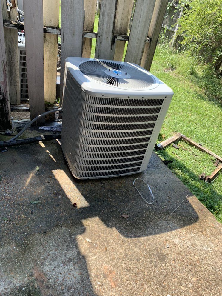 AC condenser unit installed outside a home in Mobile, AL