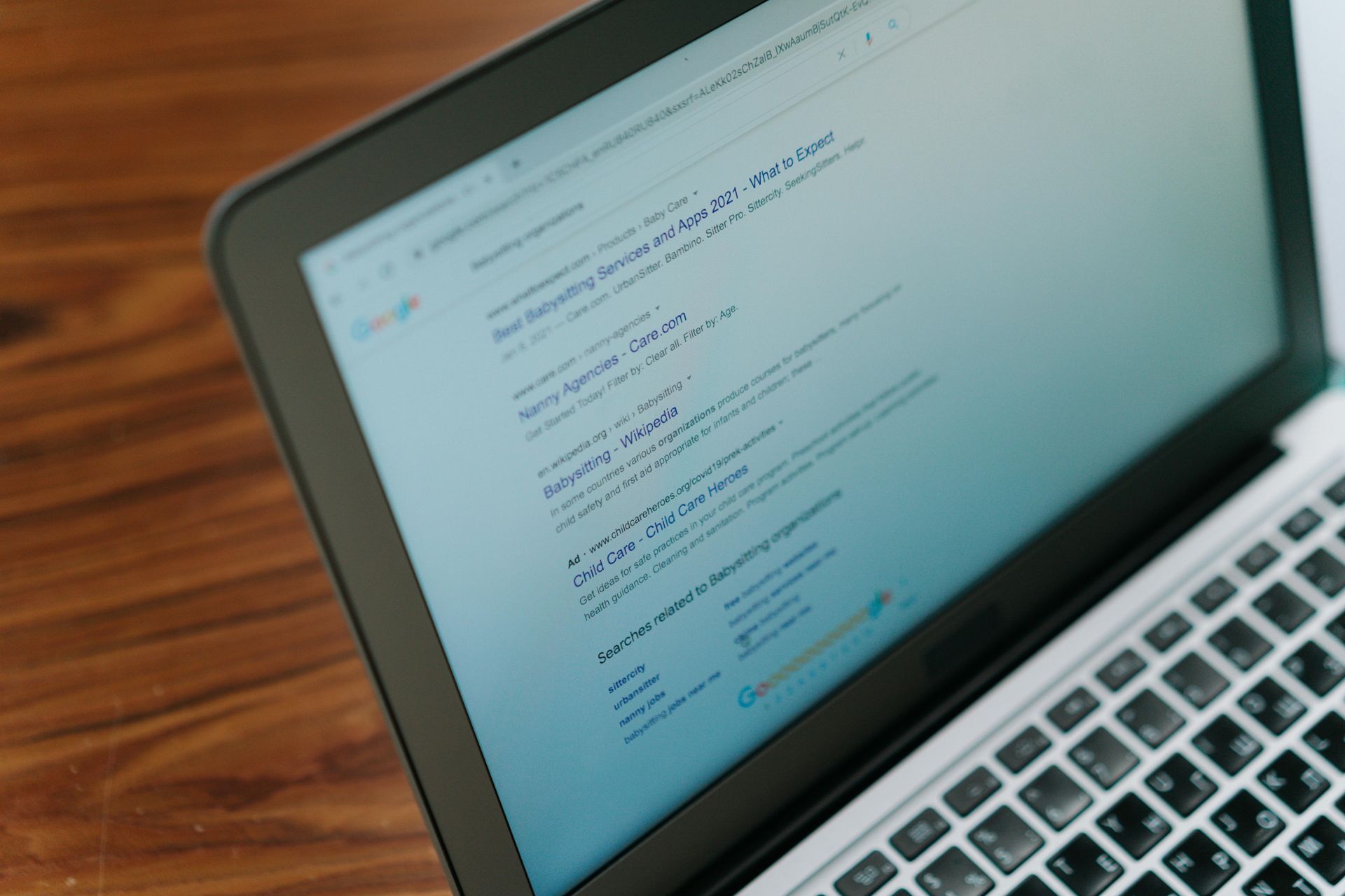 A close up of a laptop with search results on a computer.