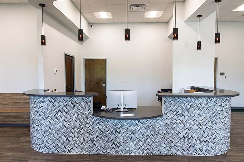 Secondary reception desk with mosaic tile detail at Animal Emergency Care of Braselton