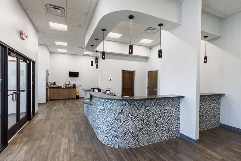 Reception desk with mosaic tile accent and modern finishes at Animal Emergency Care of Braselton