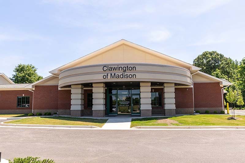 Exterior front view of Clawington of Madison building with signage and parking area