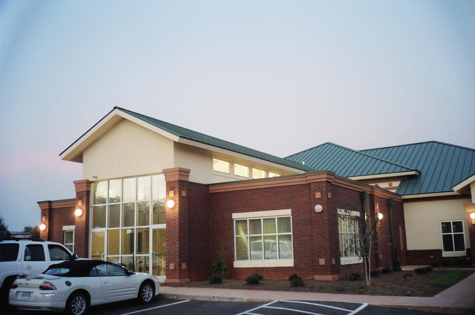 Exterior side view of Cherokee Trail Veterinary Hospital showing brick facade and large windows in Lexington SC