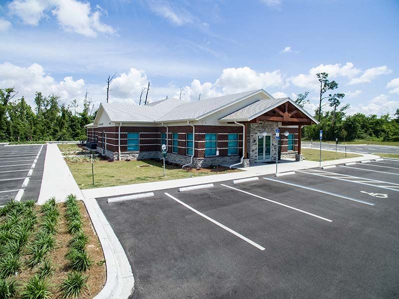 Exterior front entrance of Critter Care veterinary clinic with parking area