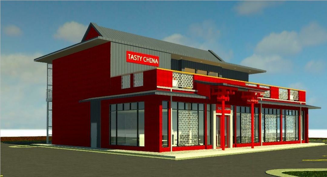 Red fast-food restaurant with large glass windows and white trim on a roadside corner.