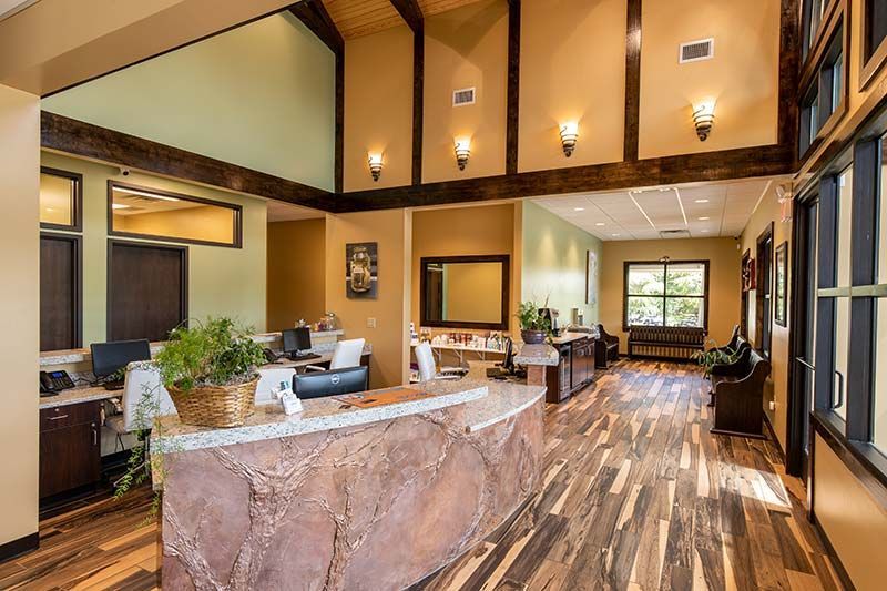Seating area with decorative flooring and warm interior finishes at Grace Animal Hospital