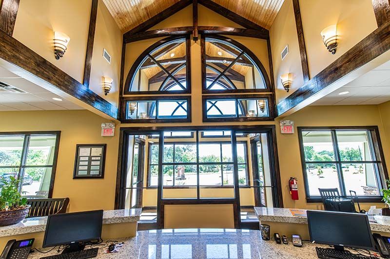 Grand interior entrance with arched windows and natural light at Grace Animal Hospital