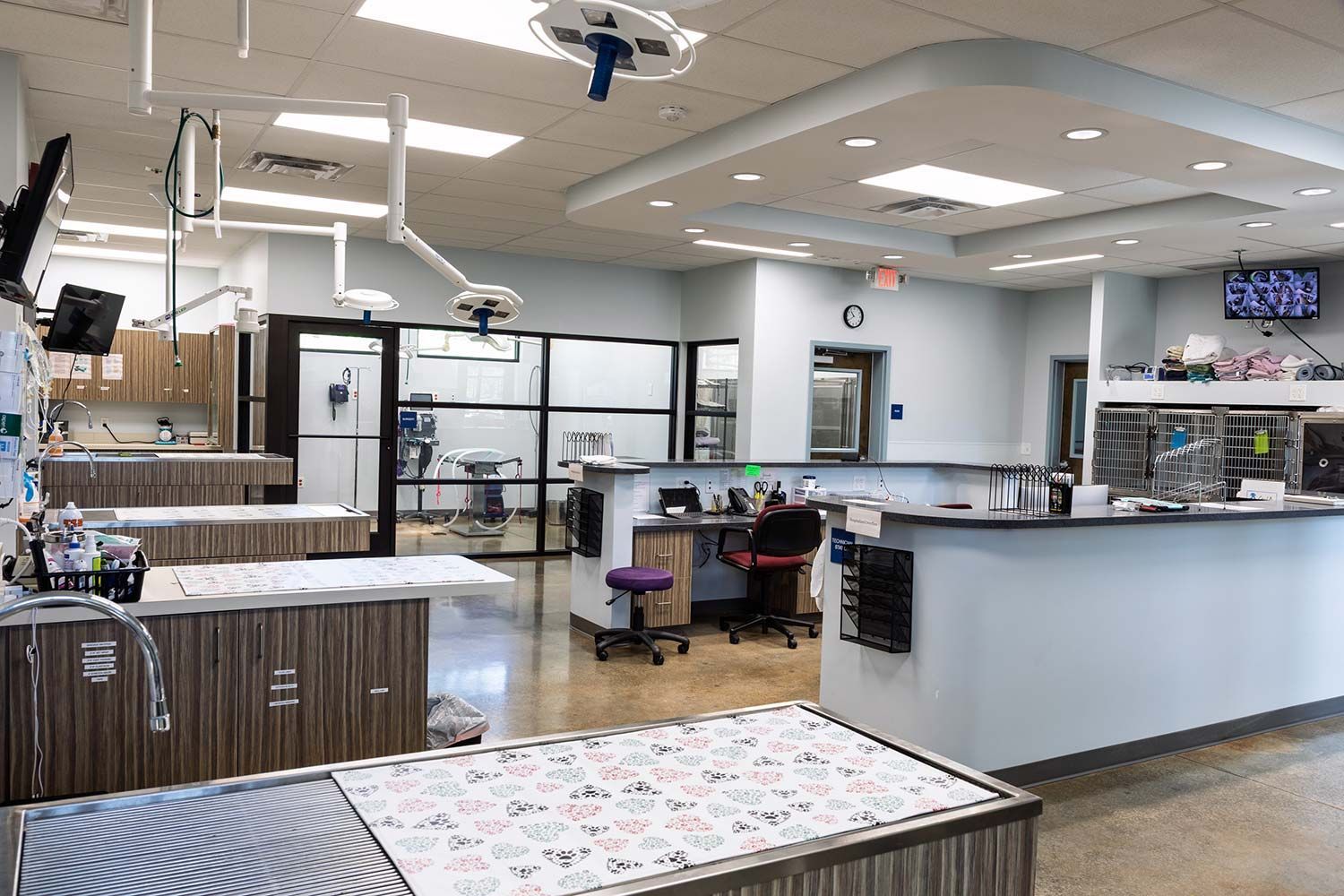 Modern laundromat with rows of washers, folding tables, and a bright tiled interior