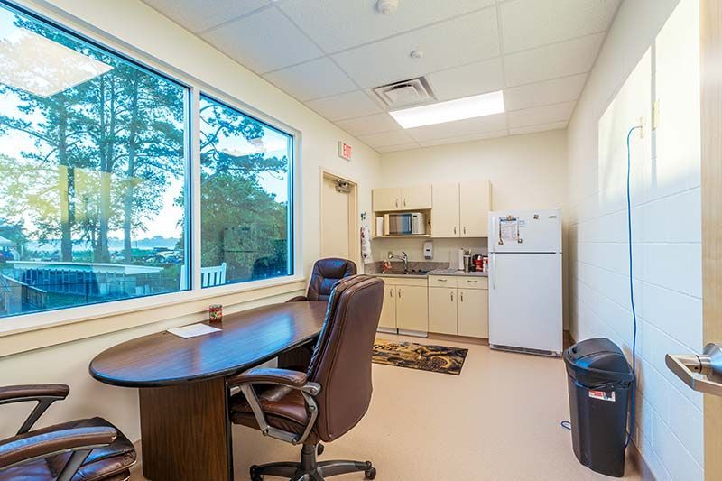 Private office workspace with large windows and natural light at Pamlico Animal Hospital