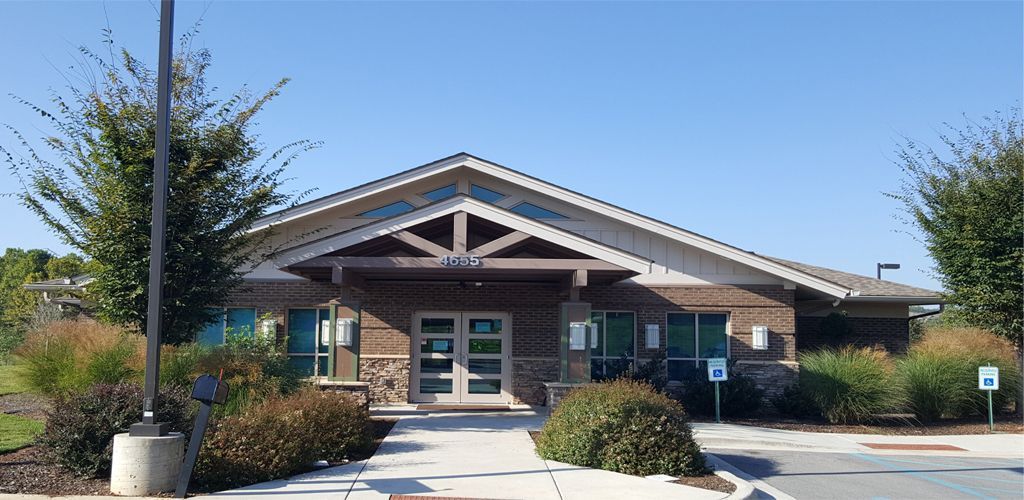Exterior front entrance of Animal Medical Clinic Huntsville with stone facade and landscaping