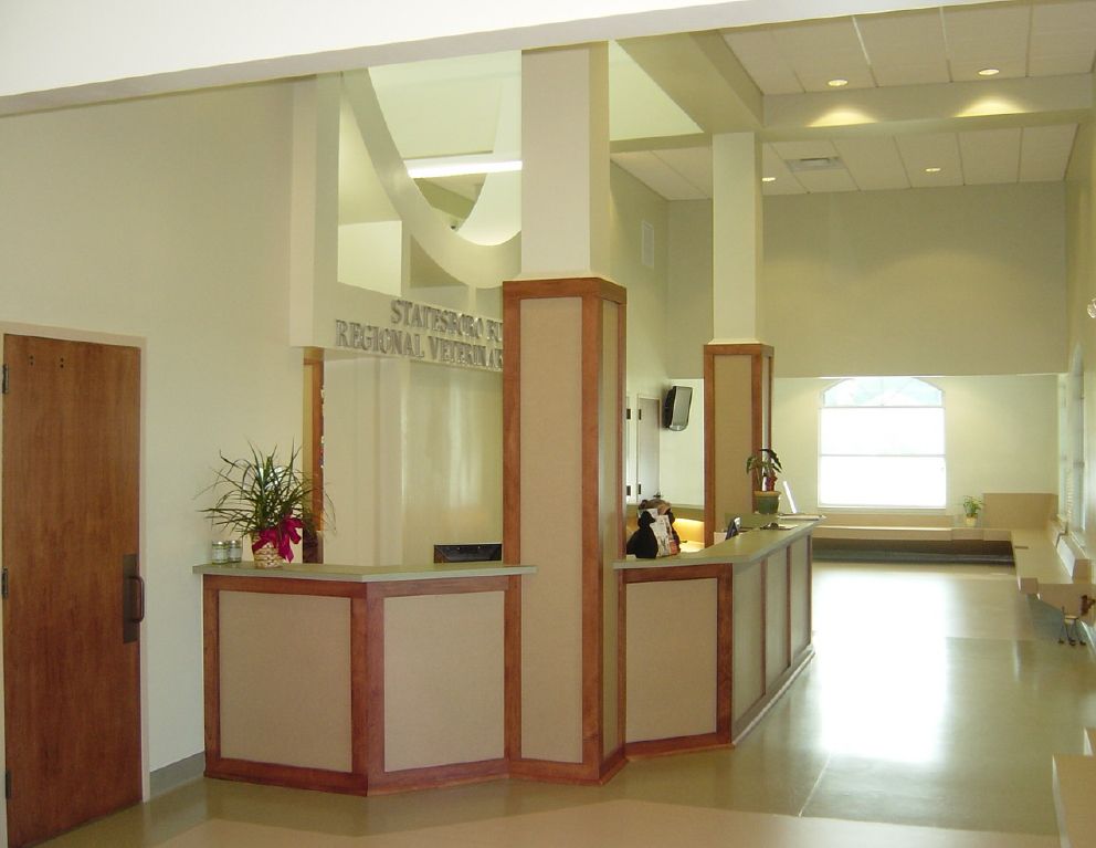 Reception desk with wood accents and open lobby at Statesboro Bulloch Regional Veterinary Hospital