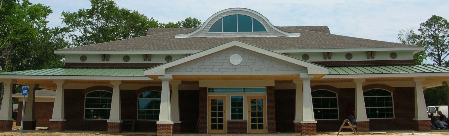 Exterior front entrance of Statesboro Bulloch Regional Veterinary Hospital with arched window and brick facade