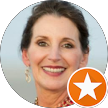 Smiling portrait of a woman with dark hair, wearing a white top, with an orange star badge overlay