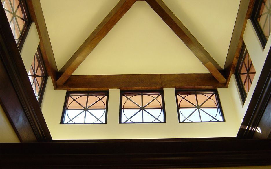 Interior vaulted ceiling with exposed timber beams and decorative windows at Veterinary Emergency Referral Center
