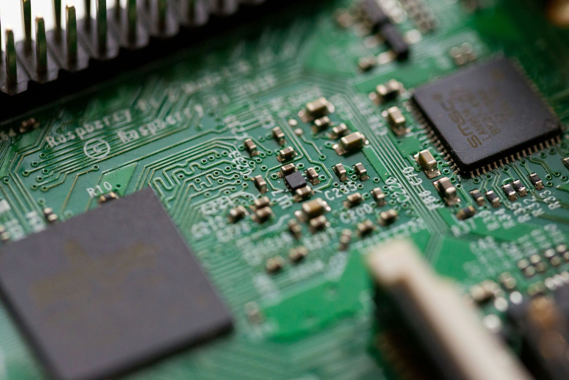A close up of a computer motherboard with a lot of electronic components on it.