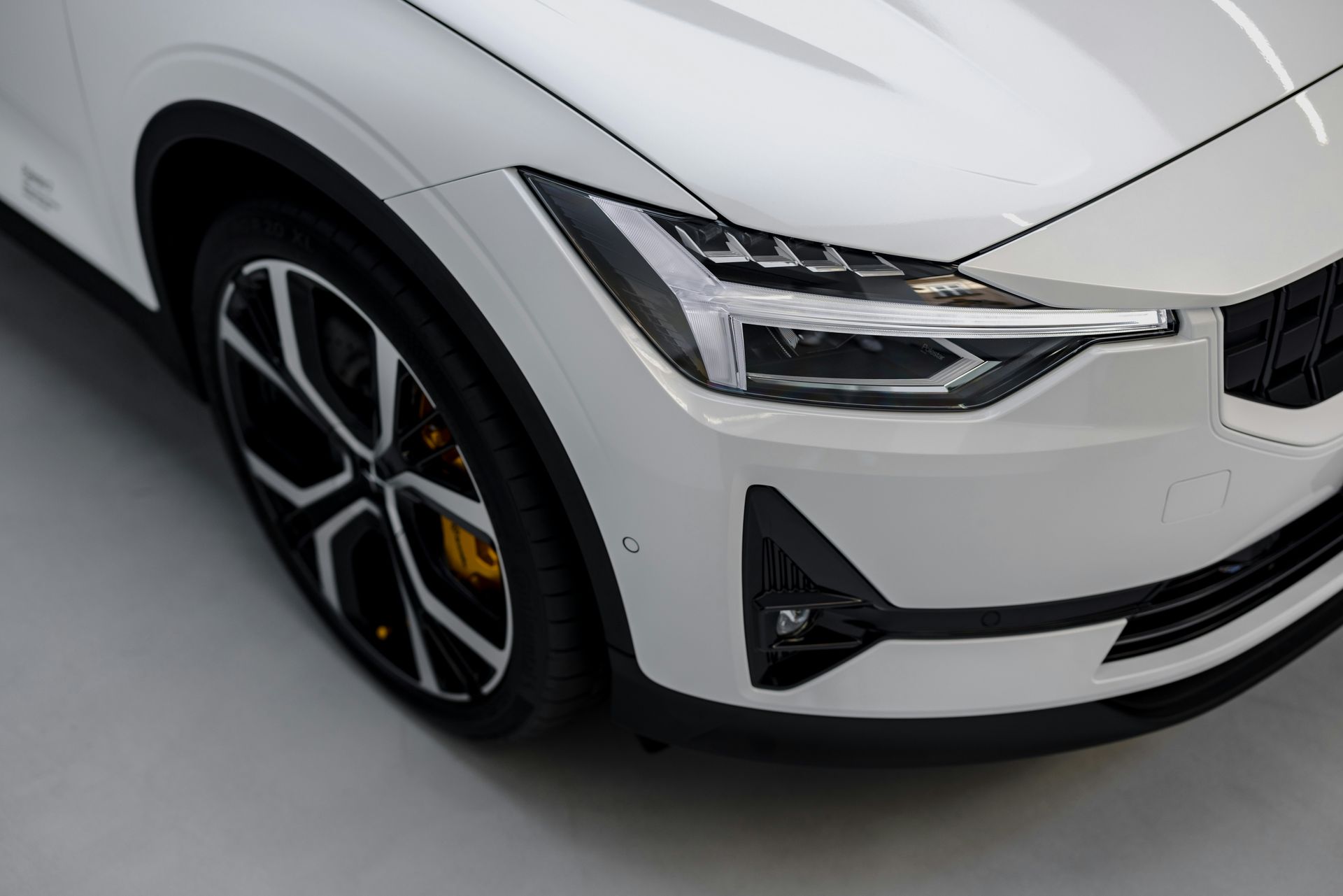 A close up of the front of a white car