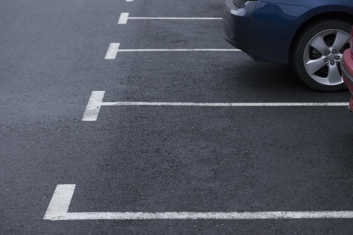 A Blue Car is Parked in a Parking Lot Next to a Red Car — North Coast Line Marking in Coffs Harbour, NSW