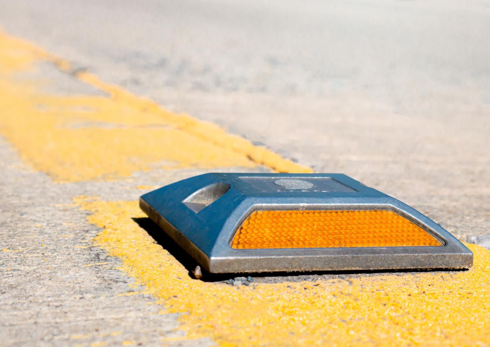 A Reflective Marker is Sitting on the Side of a Road Next to a Yellow Line — North Coast Line Marking in Talofa, NSW