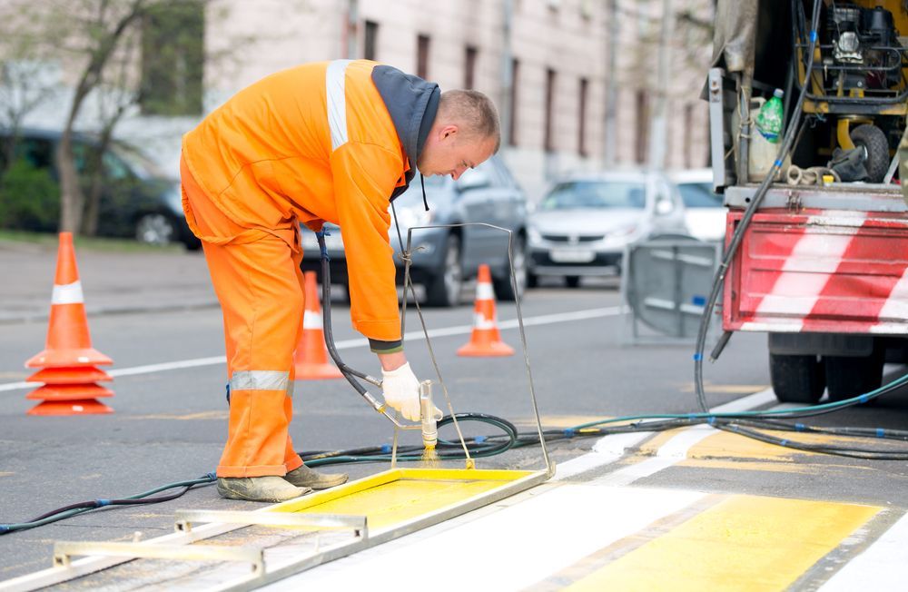 A Man is Painting a Yellow Line on the Side of the Road — North Coast Line Marking in Brunswick Heads, NSW