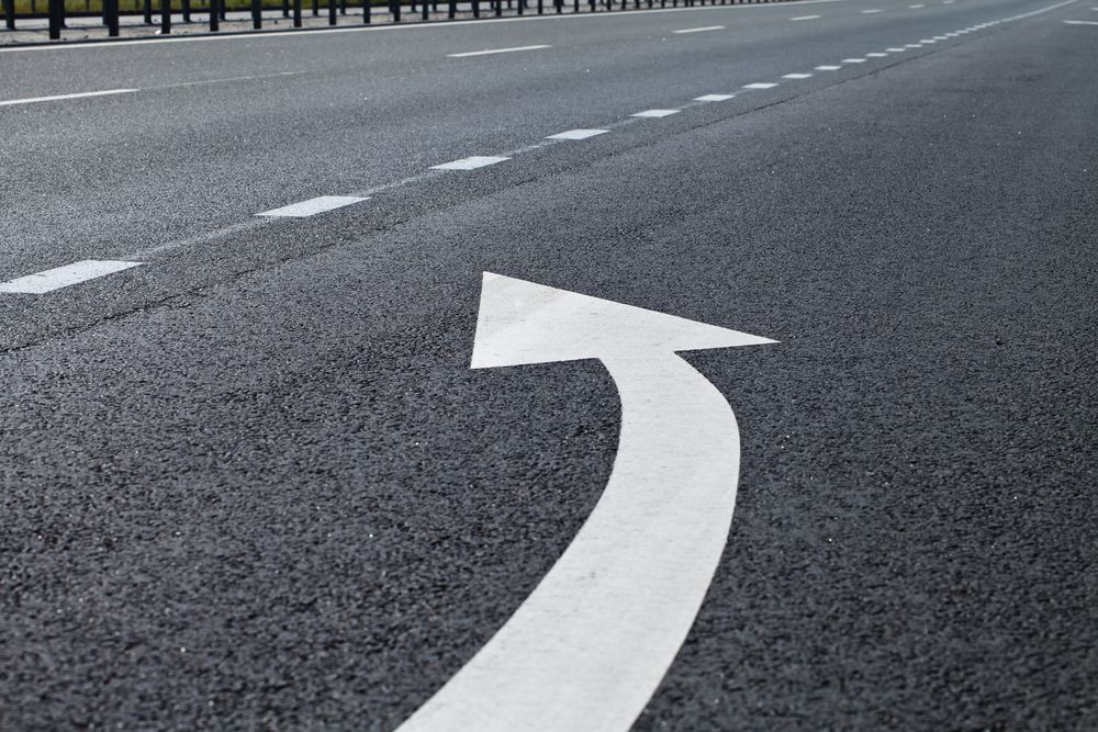 A White Arrow is Painted on the Side of a Road — North Coast Line Marking in Lismore, NSW